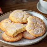 A stack of cheesecake cookies with a gooey cheesecake filling inside.